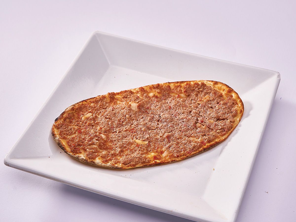 Meat with tomatoes on dough
