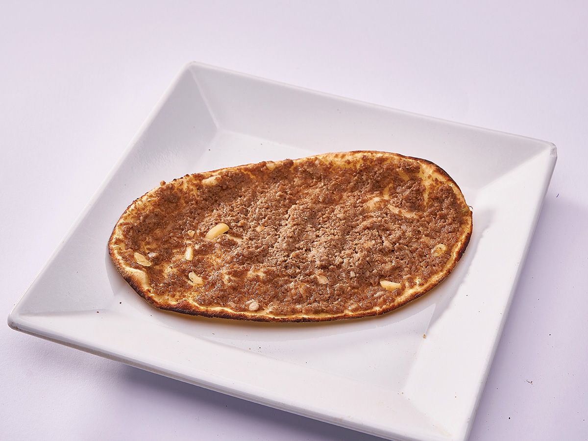 Meat piece with yogurt on dough