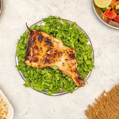 Quarter grilled chicken leg and rice